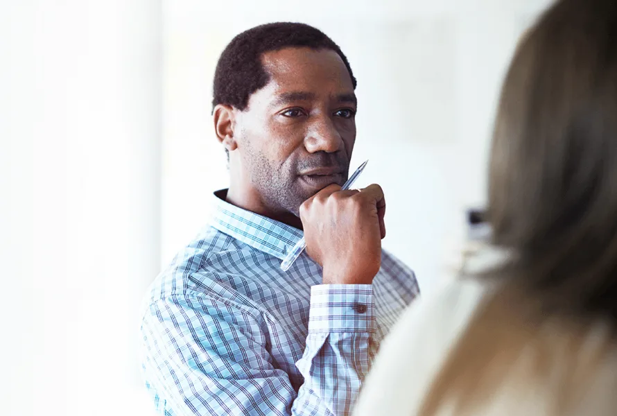 Man listening with a pen in his hand