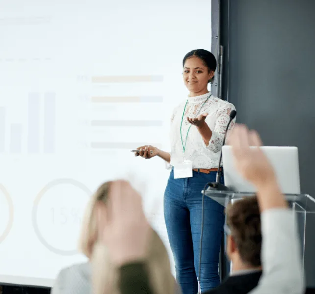 woman giving a speech to a group of people